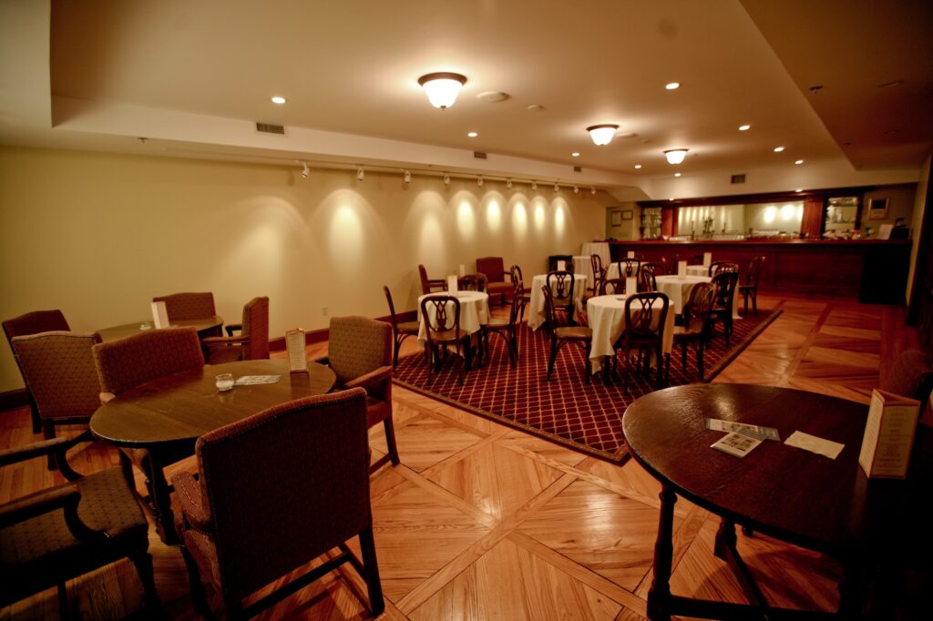 Elegant restaurant interior with round tables and warm lighting, creating an inviting dining atmosphere.